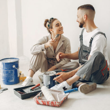Family repairs. Couple at home. Woman in a overalls